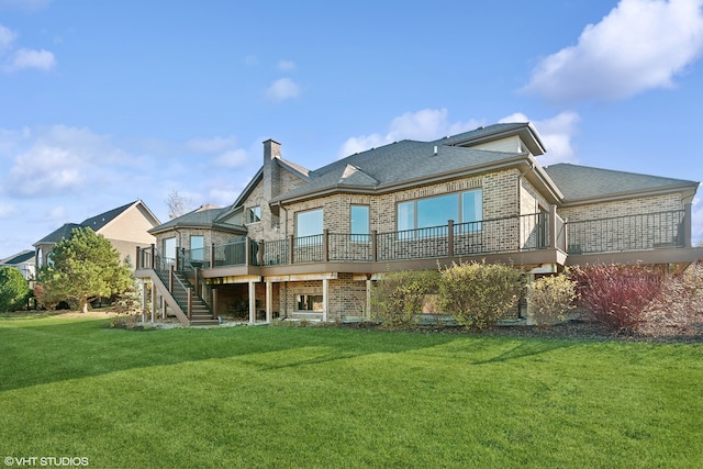 back of property featuring a wooden deck and a yard