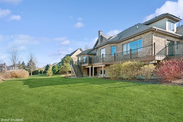 back of house with a lawn and a wooden deck