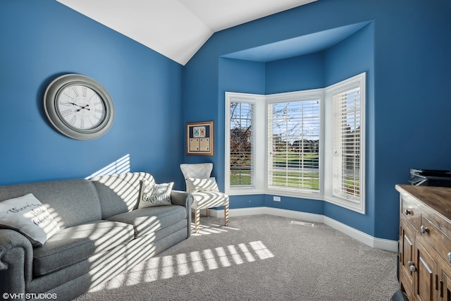 living area featuring vaulted ceiling and carpet floors