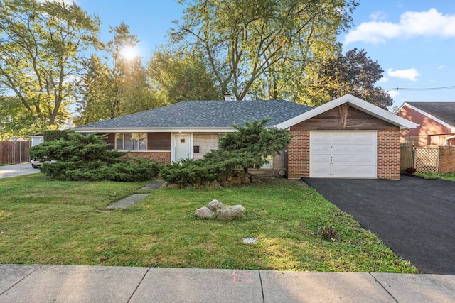 single story home featuring a garage and a front yard