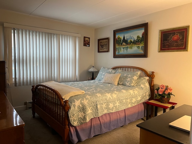 carpeted bedroom featuring a baseboard heating unit