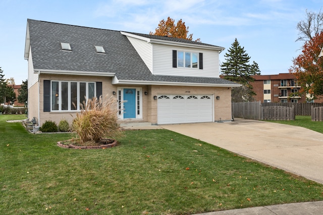 view of front of property featuring a front lawn and a garage