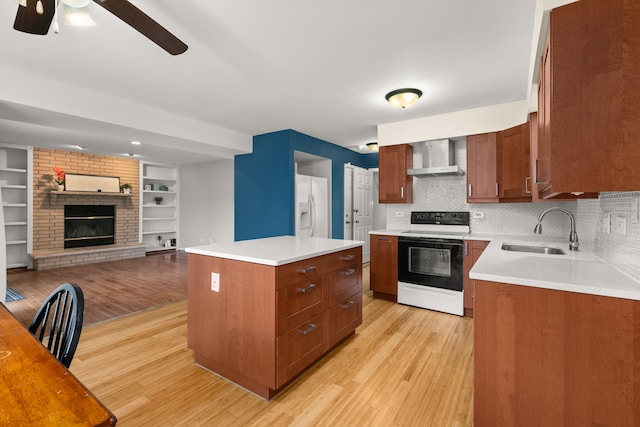 kitchen featuring a kitchen island, light wood-type flooring, white appliances, and sink