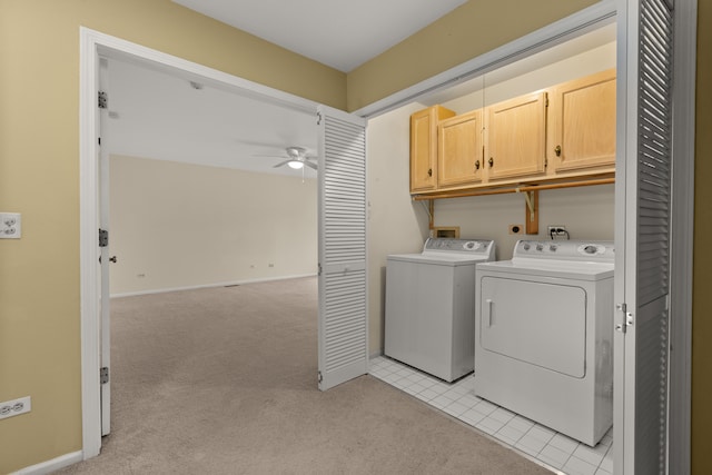 laundry area featuring cabinets, ceiling fan, light colored carpet, and washer and clothes dryer