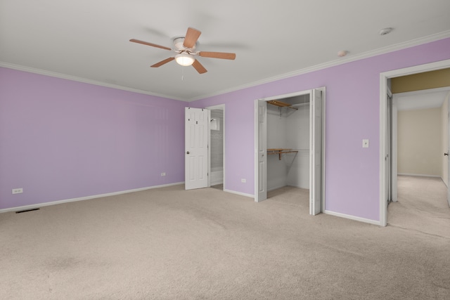 unfurnished bedroom featuring ceiling fan, crown molding, and light colored carpet