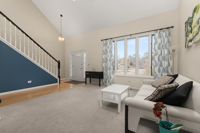 living room featuring high vaulted ceiling and light hardwood / wood-style floors