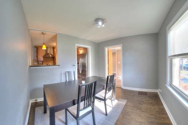 dining area featuring dark wood-type flooring