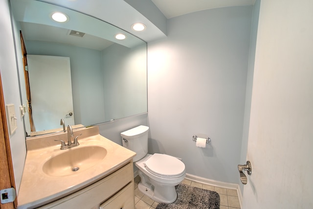 bathroom featuring toilet, vanity, and tile patterned flooring