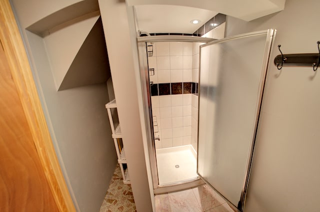 bathroom featuring a shower with shower door