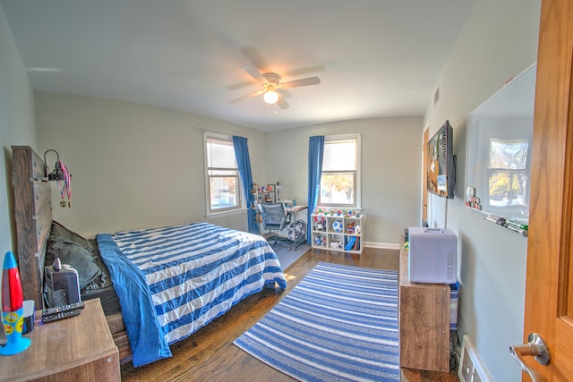 bedroom with ceiling fan and dark hardwood / wood-style floors