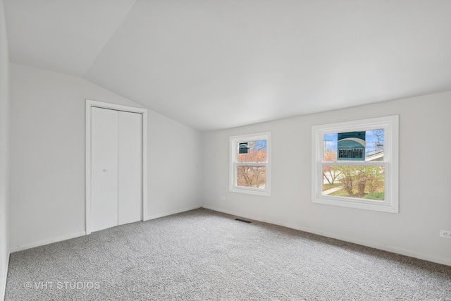 bonus room with carpet flooring and lofted ceiling