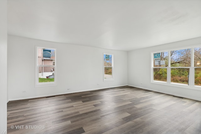 unfurnished room with dark hardwood / wood-style floors