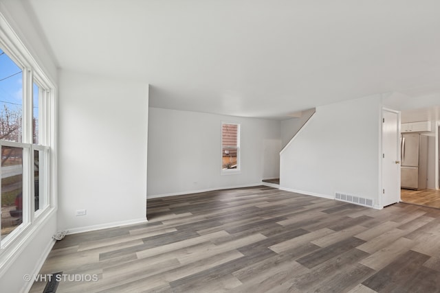 unfurnished living room featuring wood-type flooring