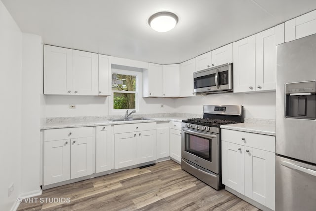 kitchen featuring white cabinets, appliances with stainless steel finishes, and sink