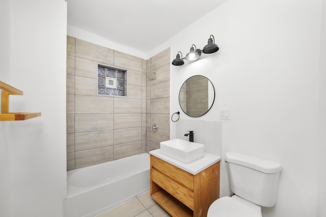 full bathroom featuring tile patterned flooring, vanity, tiled shower / bath combo, and toilet