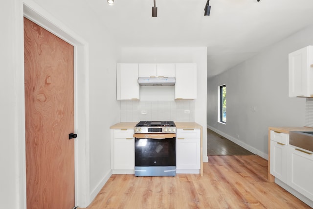 kitchen featuring white cabinetry, light hardwood / wood-style flooring, tasteful backsplash, and stainless steel gas range oven