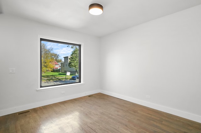 unfurnished room featuring hardwood / wood-style floors