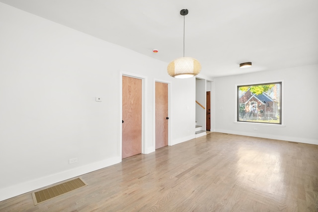 spare room featuring light wood-type flooring