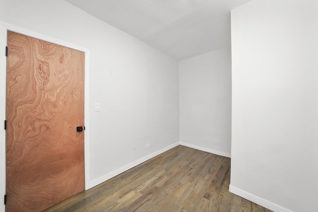 empty room with hardwood / wood-style flooring