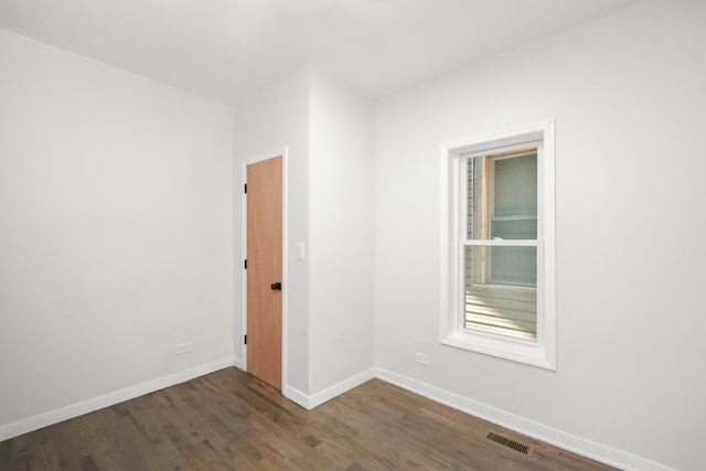 spare room featuring dark hardwood / wood-style flooring