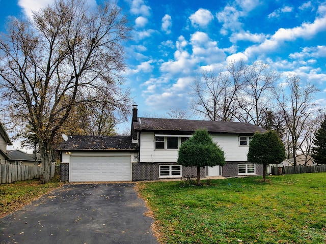 view of front of property with a garage and a front yard