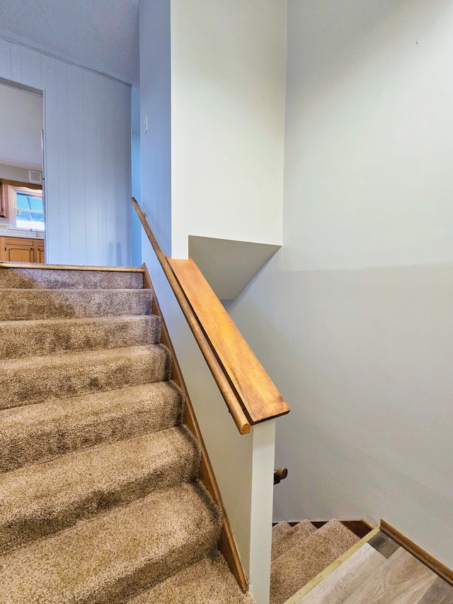 stairs featuring hardwood / wood-style floors