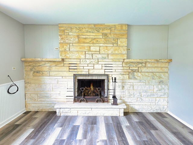 interior details with a fireplace and wood-type flooring