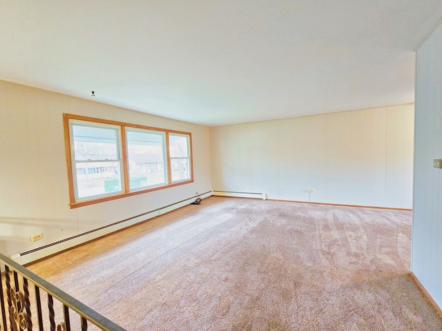 empty room featuring carpet flooring and a baseboard heating unit