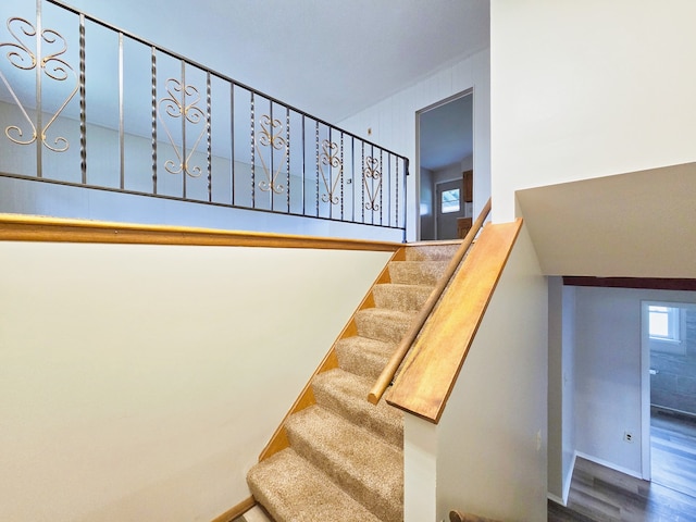 stairs featuring wood-type flooring