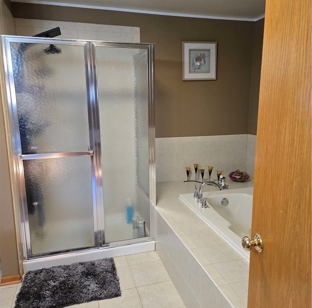 full bathroom with a shower stall, a bath, and tile patterned floors