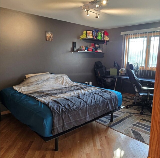 bedroom with hardwood / wood-style flooring