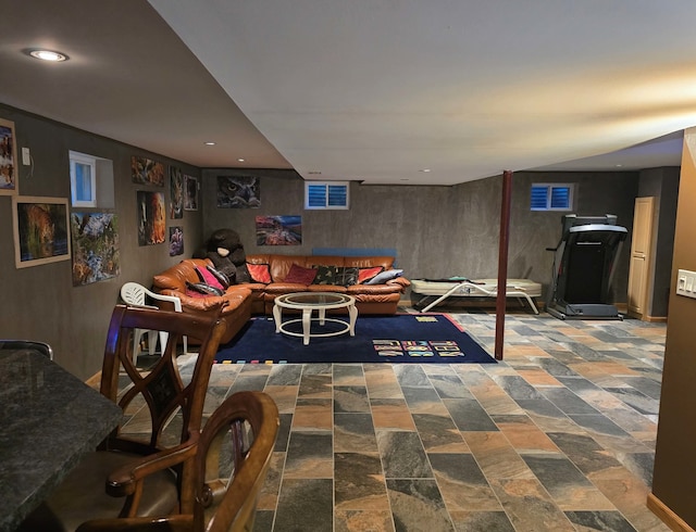 recreation room with stone finish flooring and recessed lighting