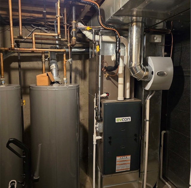 utility room featuring water heater