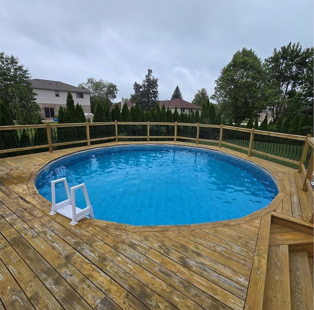 view of pool with a fenced in pool and a wooden deck