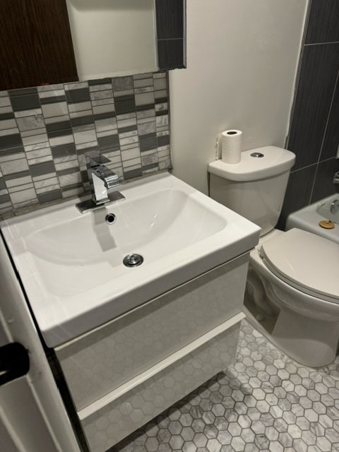 bathroom with tile patterned flooring, toilet, and sink