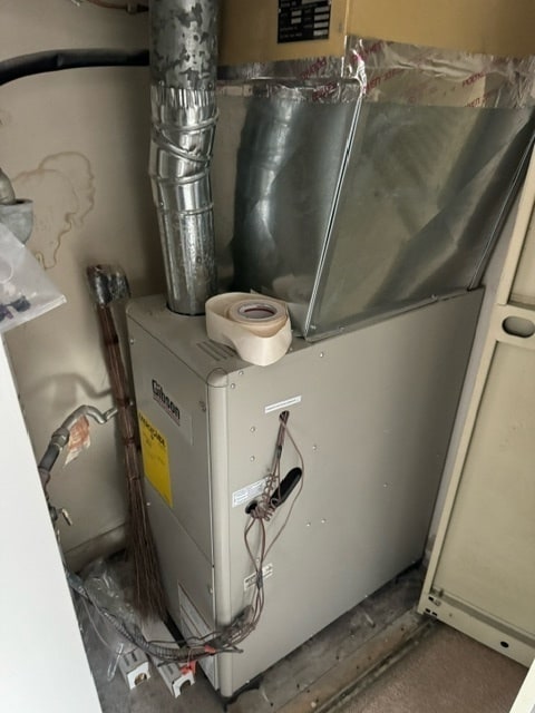 utility room with heating unit