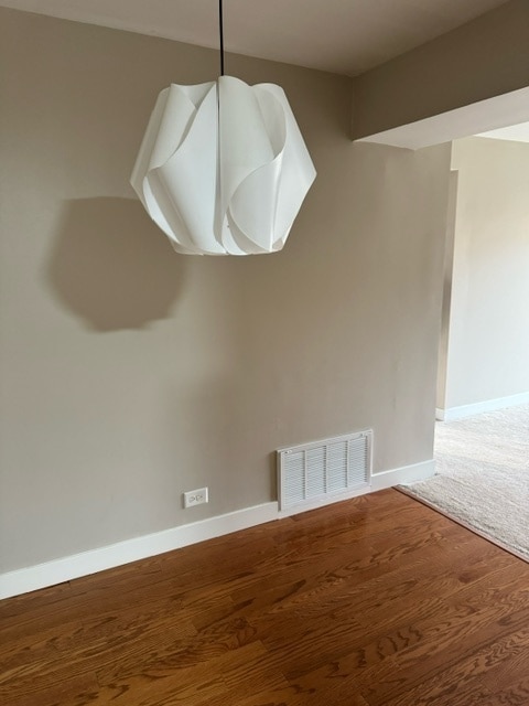 unfurnished dining area featuring wood-type flooring