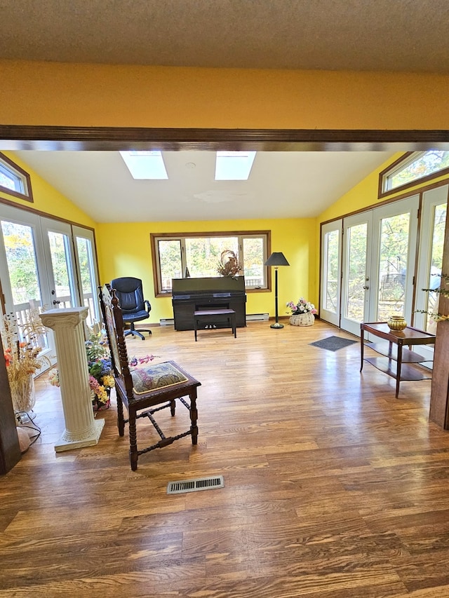 sitting room featuring lofted ceiling with skylight, french doors, and visible vents