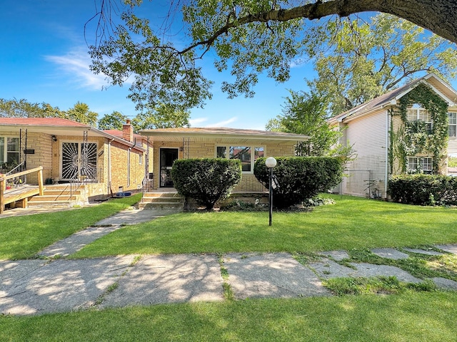 view of front of house featuring a front yard and brick siding