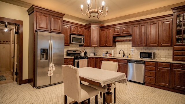 kitchen featuring sink, appliances with stainless steel finishes, backsplash, a chandelier, and crown molding