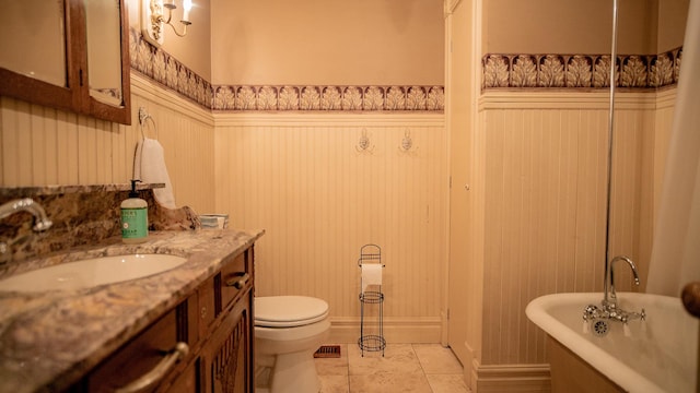 608 E Ash St, Fairbury, IL 61739 - full bathroom with a soaking tub, visible vents, toilet, and vanity