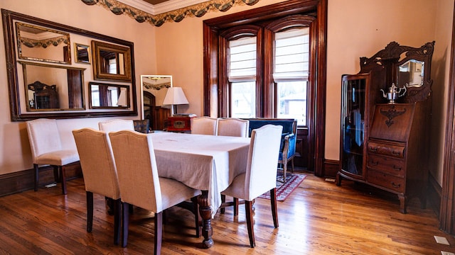 608 E Ash St, Fairbury, IL 61739 - dining space with crown molding, wood finished floors, and baseboards