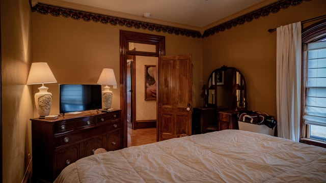 bedroom featuring light hardwood / wood-style floors and ornamental molding