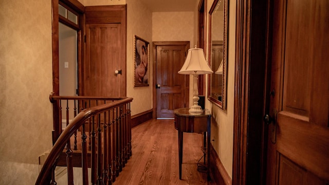 608 E Ash St, Fairbury, IL 61739 - corridor with an upstairs landing, wood finished floors, a textured wall, and baseboards