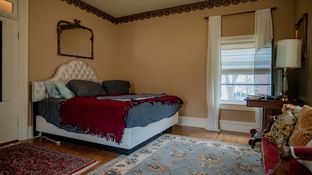 bedroom with wood-type flooring