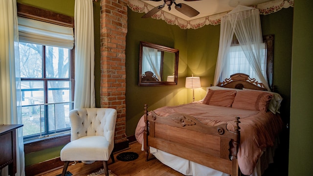 bedroom with hardwood / wood-style flooring and ceiling fan