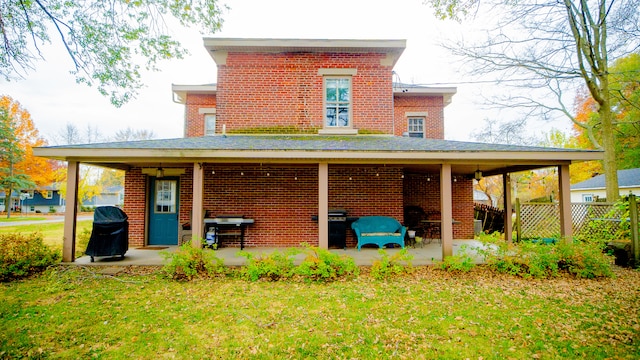 back of house with a yard and a patio area