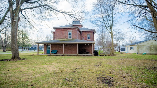 608 E Ash St, Fairbury, IL 61739 - back of house with a lawn, a chimney, and brick siding
