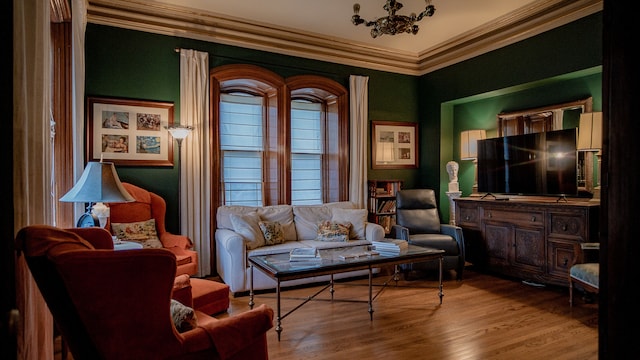 living area featuring light wood-type flooring and crown molding