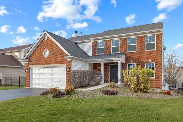 view of front of house featuring a front lawn, a porch, and a garage